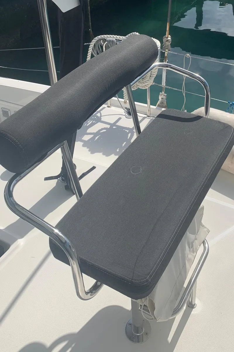 Slide: The Image of Helm seat on 2019 Lagoon 42 catamaran, featuring sleek design and comfortable padding. - 4