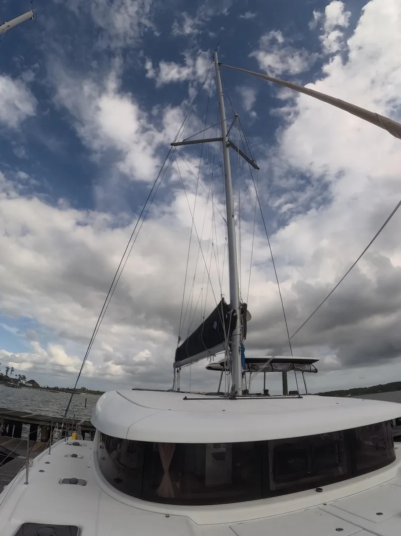 Slide: The Image of 2019 Lagoon 42 catamaran with sails, under a partly cloudy sky. - 41