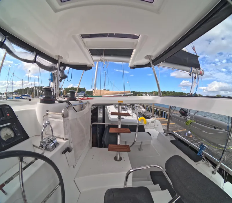 Slide: The Image of Interior view of a 2019 Lagoon 42 catamaran, showcasing helm and seating area. - 45