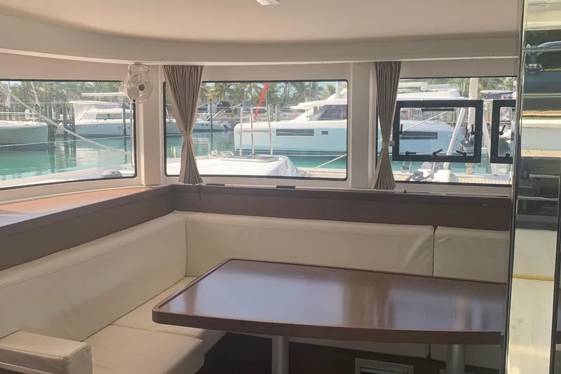 Slide: The Image of Interior of 2019 Lagoon 42 yacht with seating and table, marina view. - 9