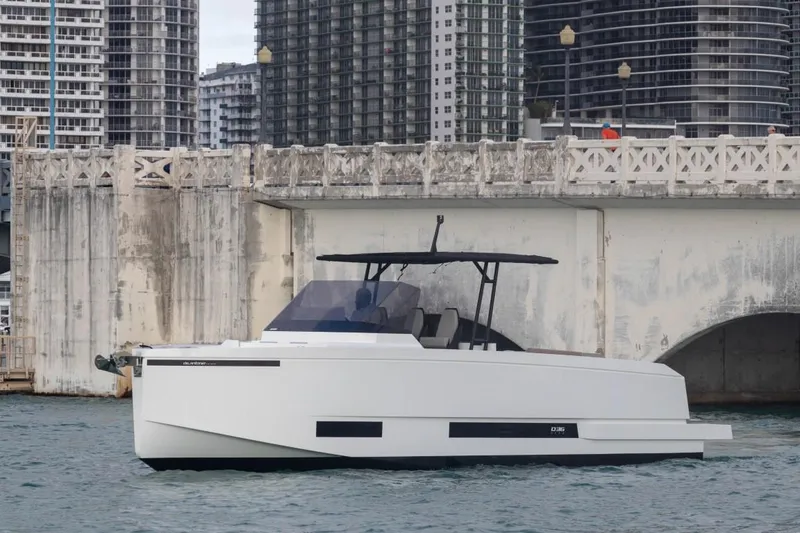 Slide: The Image of 2024 De Antonio Yachts D36 OPEN cruising near a bridge in an urban setting. - 0