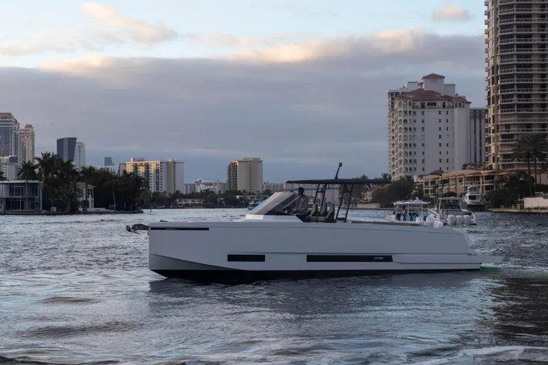 Slide: The Image of 2024 De Antonio Yachts D36 OPEN cruising in urban waterfront setting. - 5