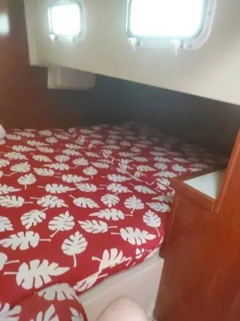 Slide: The Image of V-berth cabin with dark cushions in a 1988 Catalina 34 sailboat. - 31