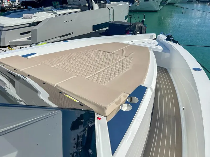 Slide: The Image of 2024 De Antonio Yachts D36 OPEN with beige sunbed, docked in marina. - 7