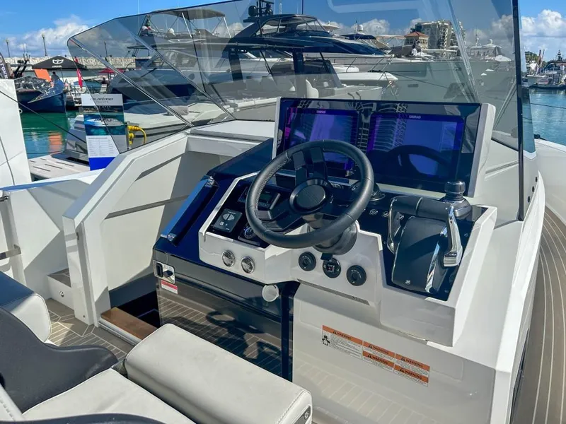 Slide: The Image of 2024 De Antonio Yachts D36 OPEN helm with modern controls and navigation displays. - 9