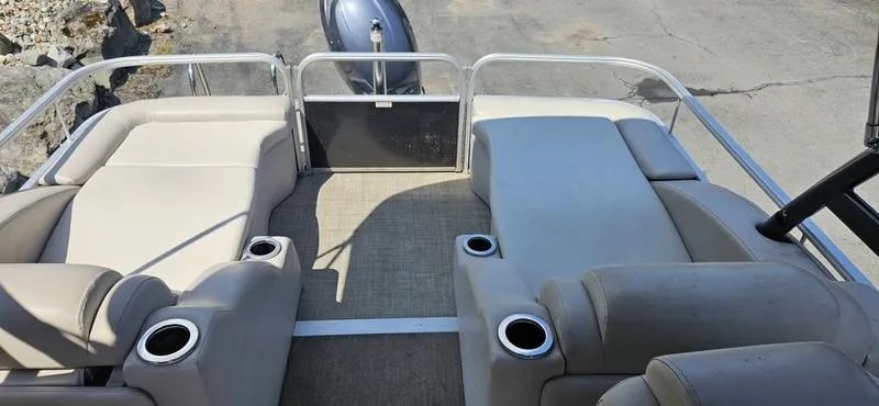 Slide: The Image of 2013 Bennington 2375 GCW pontoon boat interior with beige seating and cup holders. - 10