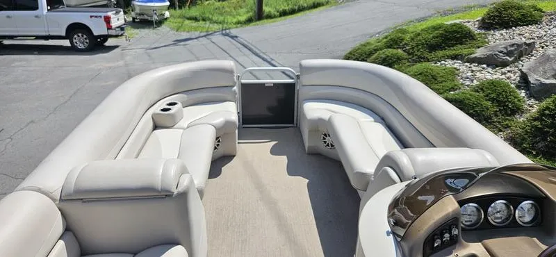 Slide: The Image of 2013 Bennington 2375 GCW pontoon boat interior with plush seating and dashboard view. - 11