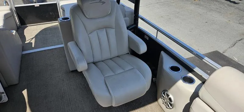Slide: The Image of 2013 Bennington 2375 GCW boat interior with plush seating and cup holders. - 13