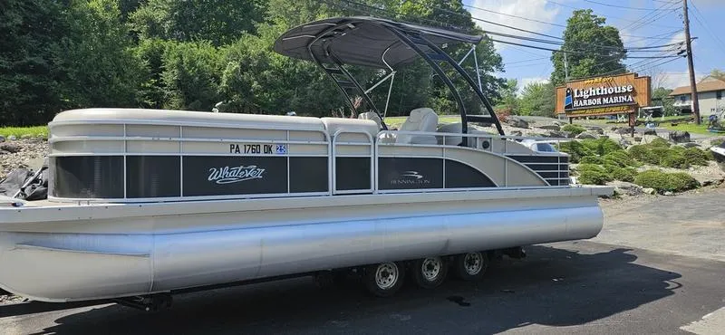 Slide: The Image of 2013 Bennington 2375 GCW pontoon boat on trailer at Lighthouse Harbor Marina. - 2