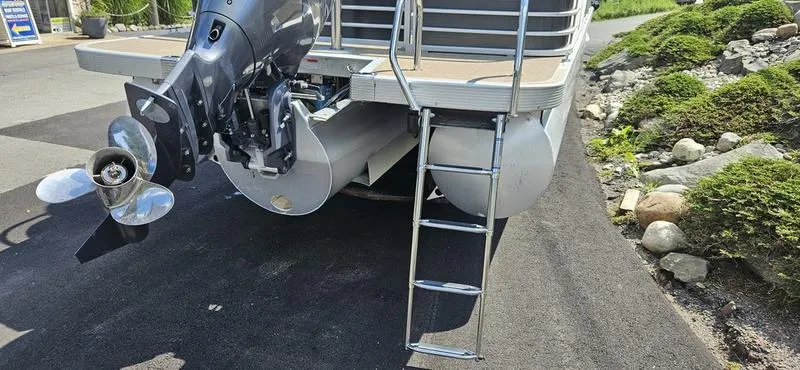 Slide: The Image of 2013 Bennington 2375 GCW pontoon boat with outboard motor and ladder on asphalt. - 4