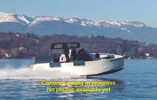 Slide: The Image of 2024 De Antonio Yachts D28 Open cruising on a scenic lake with mountains in the background. - 1