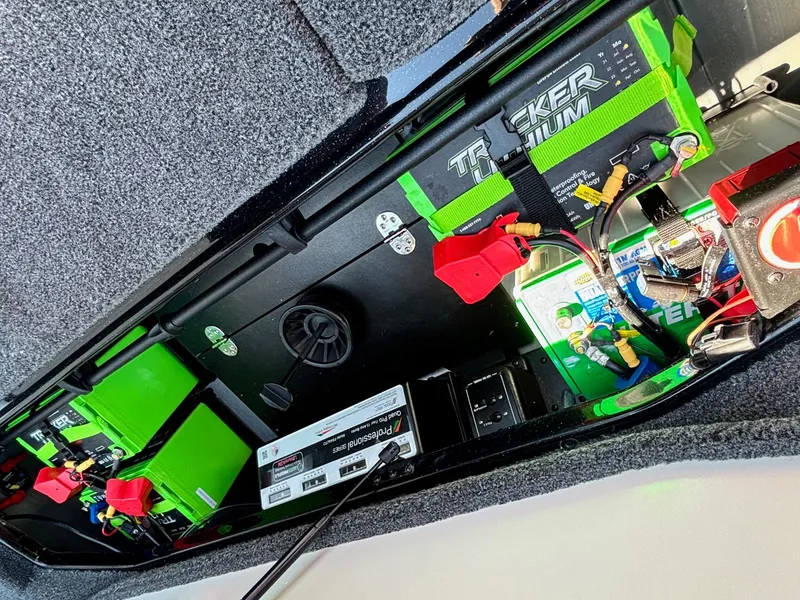 Slide: The Image of 2025 Ranger Z520R Garmin Ranger Cup battery compartment with Tracker lithium batteries and wiring. - 18