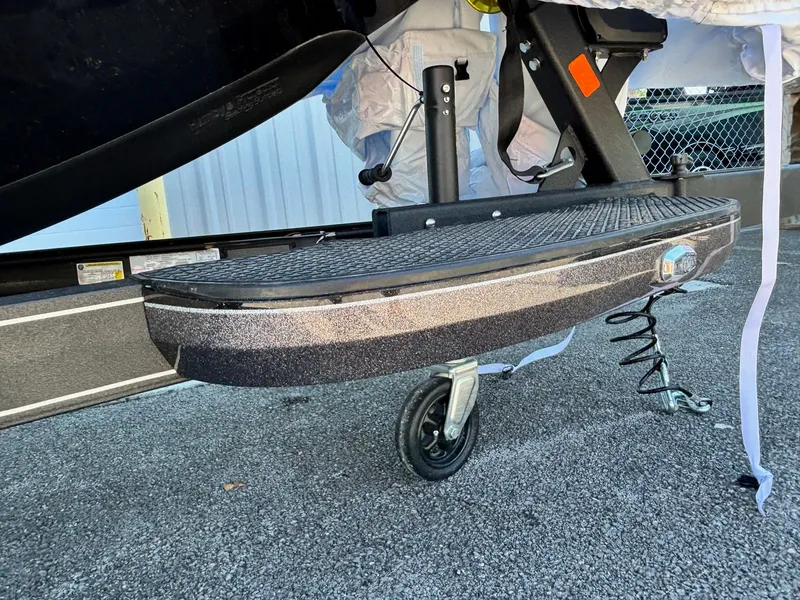 Slide: The Image of 2025 Ranger Z520R Garmin Ranger Cup trailer step with wheel on asphalt. - 3