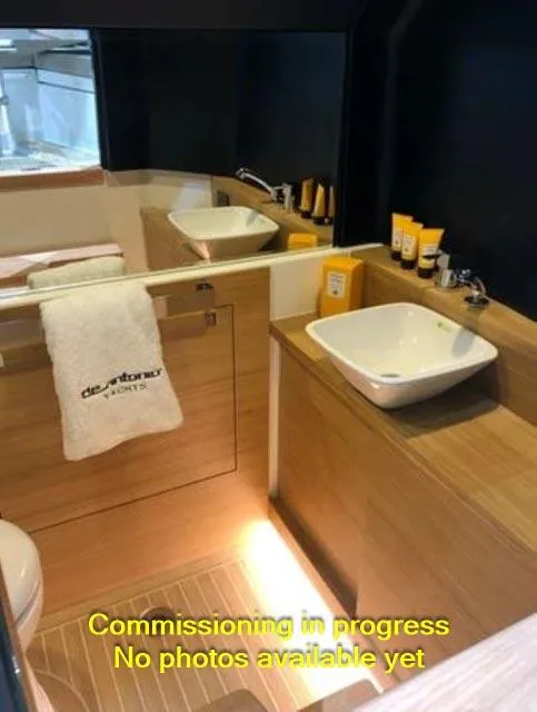 Slide: The Image of 2024 De Antonio Yachts D28 Open bathroom interior with modern sink and wooden cabinetry. - 7