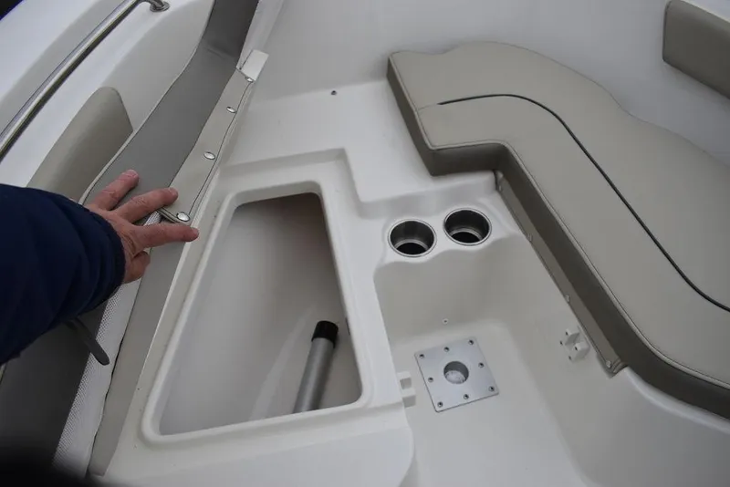 Slide: The Image of 2024 Key West 203 FS boat interior with storage compartment and cup holders. - 23