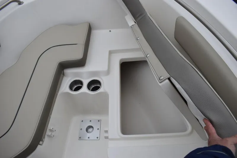 Slide: The Image of 2024 Key West 203 FS boat interior with storage compartment and cup holders. - 24