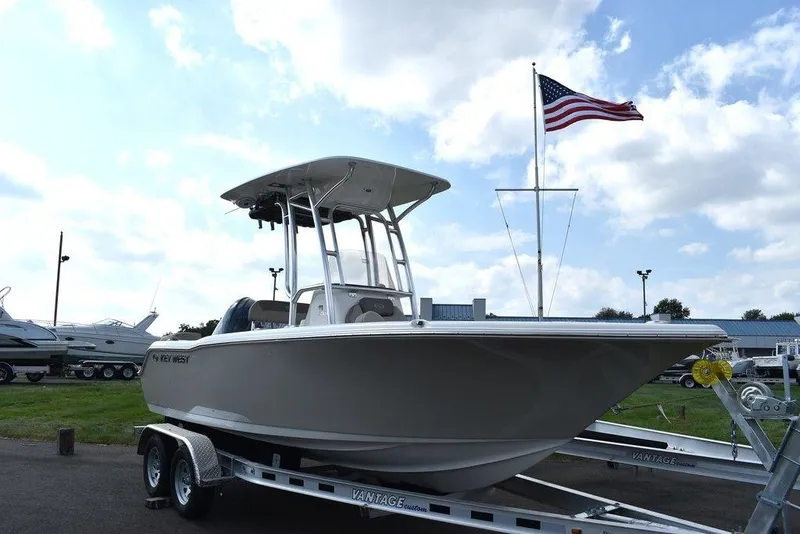 Slide: The Image of 2024 Key West 203 FS boat on trailer with American flag in background. - 3