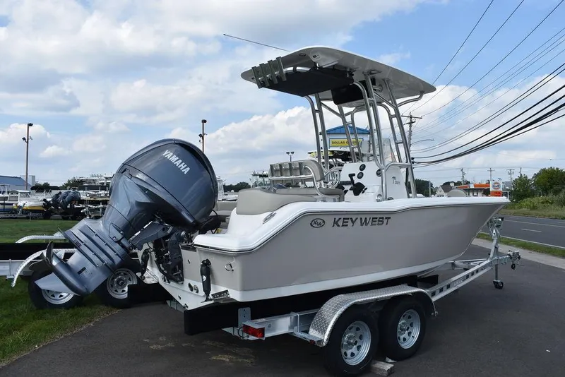 Slide: The Image of 2024 Key West 203 FS boat on trailer with Yamaha engine, parked outdoors. - 4