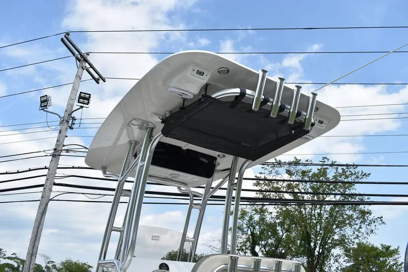 Slide: The Image of 2024 Key West 203 FS boat with T-top and rod holders against a clear sky. - 6