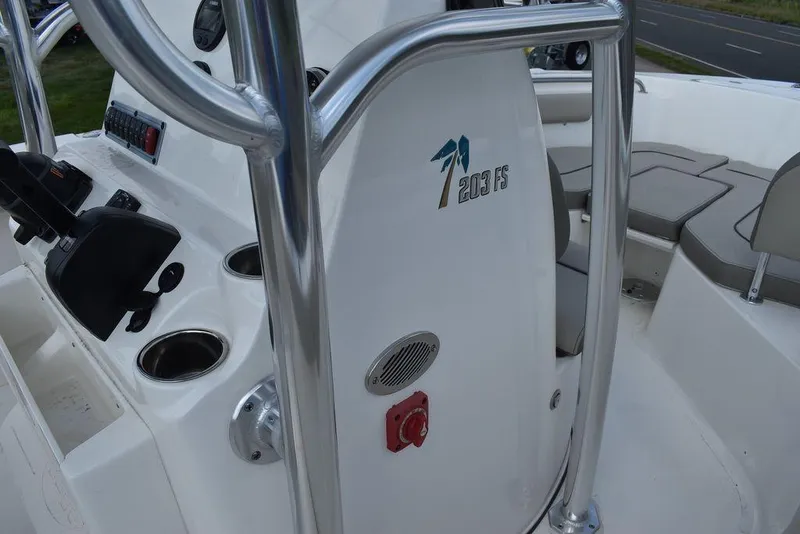 Slide: The Image of 2024 Key West 203 FS boat interior with steering console and seating area. - 9