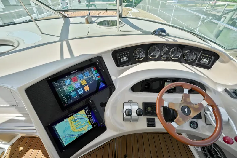 Slide: The Image of Helm of 2001 Sea Ray 510 Sundancer with modern navigation displays and wooden steering wheel. - 15