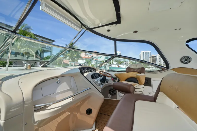 Slide: The Image of Interior of 2001 Sea Ray 510 Sundancer yacht with luxurious seating and helm. - 16
