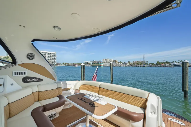 Slide: The Image of Sea Ray 510 Sundancer 2001 yacht interior with waterfront view and American flag. - 17