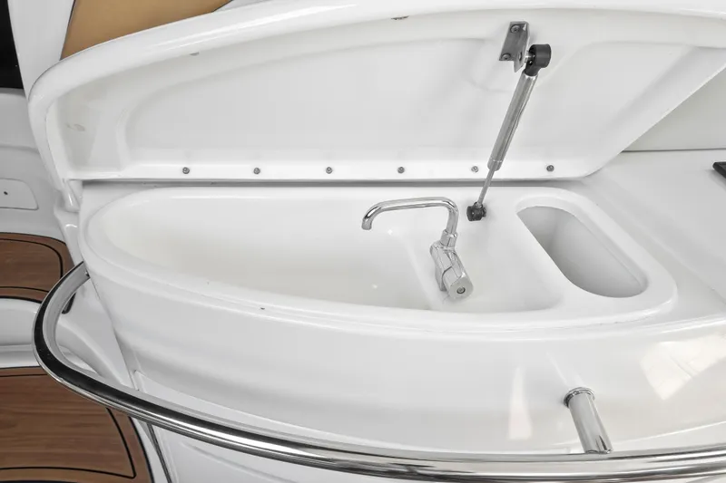 Slide: The Image of Sea Ray 510 Sundancer 2001 yacht sink with open lid and faucet. - 23