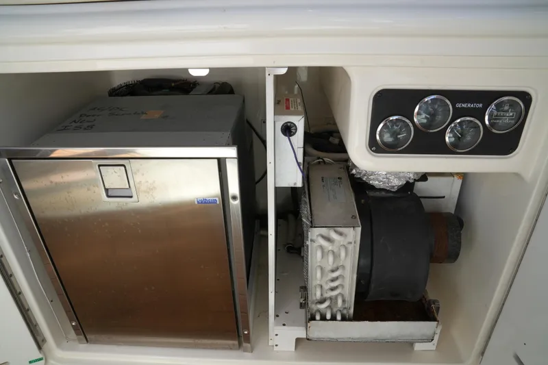 Slide: The Image of Engine compartment of 2001 Sea Ray 510 Sundancer with generator and control panel. - 25