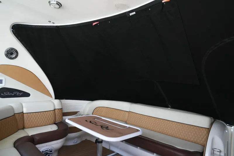 Slide: The Image of Interior of 2001 Sea Ray 510 Sundancer with cushioned seating and table. - 26