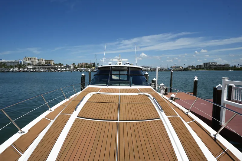 Slide: The Image of 2001 Sea Ray 510 Sundancer yacht docked with scenic waterfront view. - 28