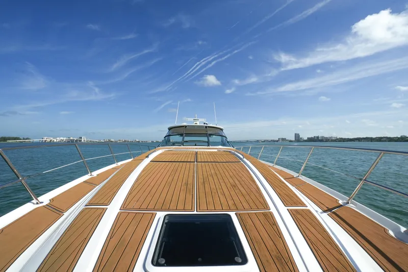 Slide: The Image of 2001 Sea Ray 510 Sundancer yacht on open water, clear sky, wooden deck. - 29