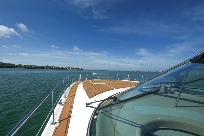 Slide: The Image of 2001 Sea Ray 510 Sundancer cruising on a sunny day, showcasing sleek deck design. - 35