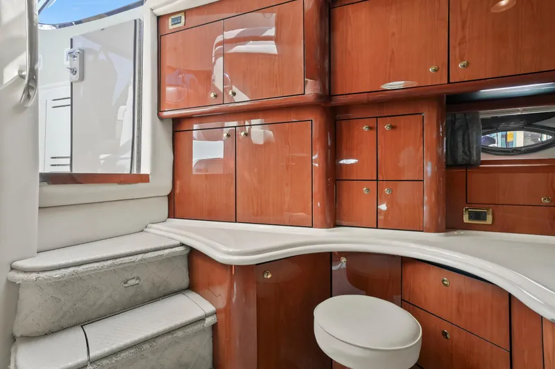 Slide: The Image of Luxurious interior of 2001 Sea Ray 510 Sundancer with polished wood cabinetry and plush seating. - 41