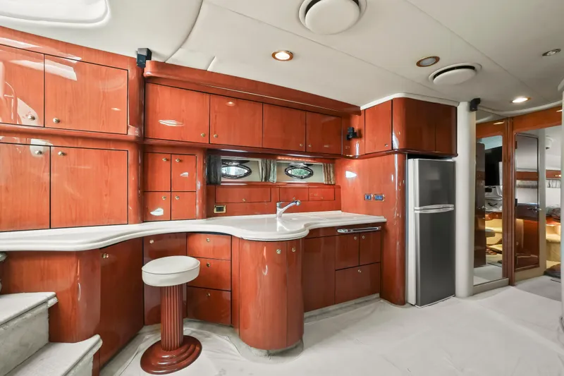 Slide: The Image of Luxurious 2001 Sea Ray 510 Sundancer yacht interior with sleek wooden cabinetry and modern appliances. - 43