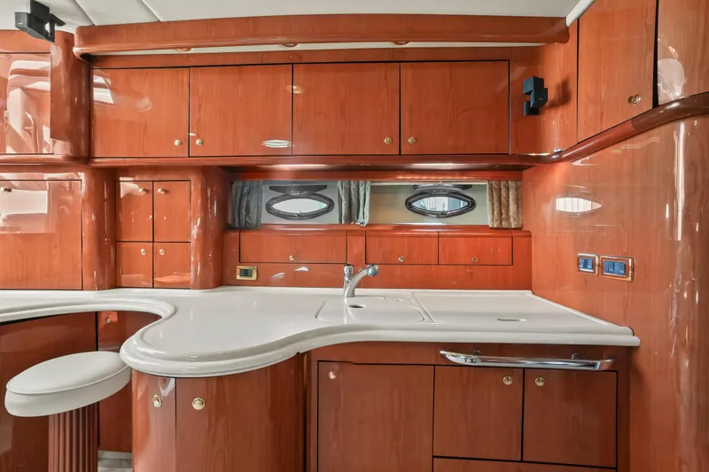 Slide: The Image of Luxurious 2001 Sea Ray 510 Sundancer yacht interior with elegant wood cabinetry and modern amenities. - 44