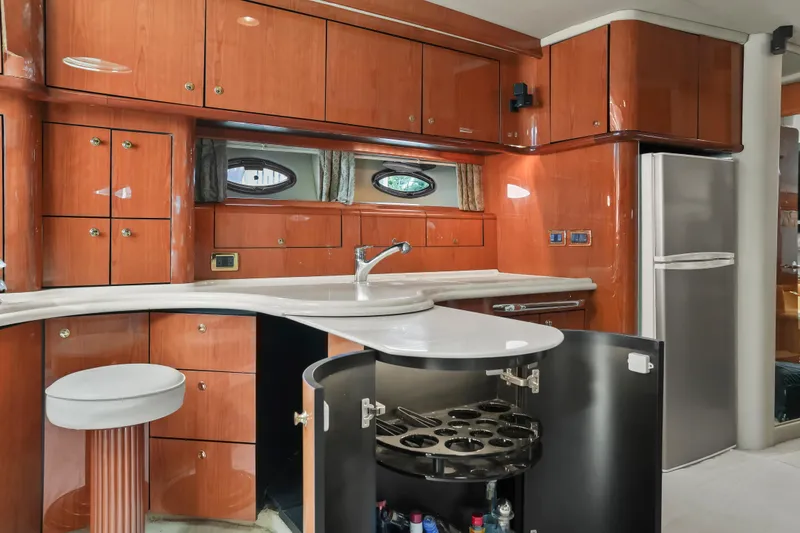 Slide: The Image of Luxurious 2001 Sea Ray 510 Sundancer yacht kitchen with wood cabinetry and modern appliances. - 45