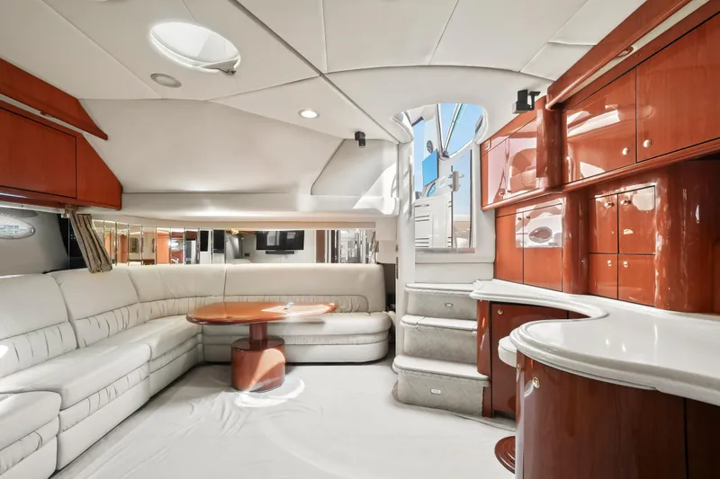 Slide: The Image of Luxurious interior of 2001 Sea Ray 510 Sundancer yacht with white leather seating and wooden cabinetry. - 47