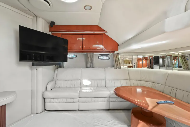 Slide: The Image of Luxurious interior of 2001 Sea Ray 510 Sundancer yacht with leather seating and TV. - 49