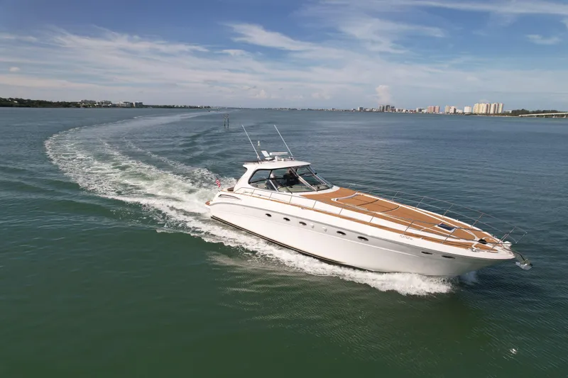 Slide: The Image of 2001 Sea Ray 510 Sundancer cruising on open water under clear skies. - 8