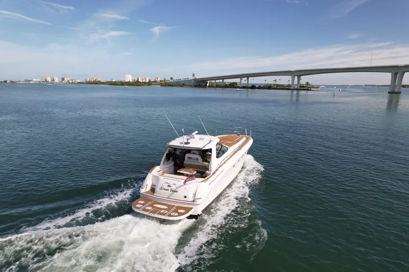 Slide: The Image of 2001 Sea Ray 510 Sundancer cruising on a calm waterway near a bridge. - 9