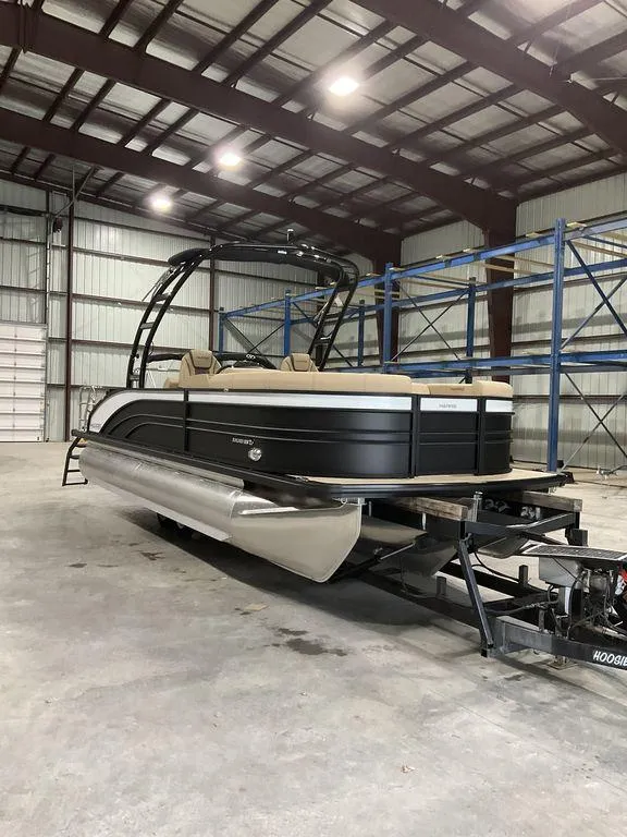 The Image of 2025 Harris Sunliner 230 Sport SLDH pontoon boat in warehouse setting. - 0