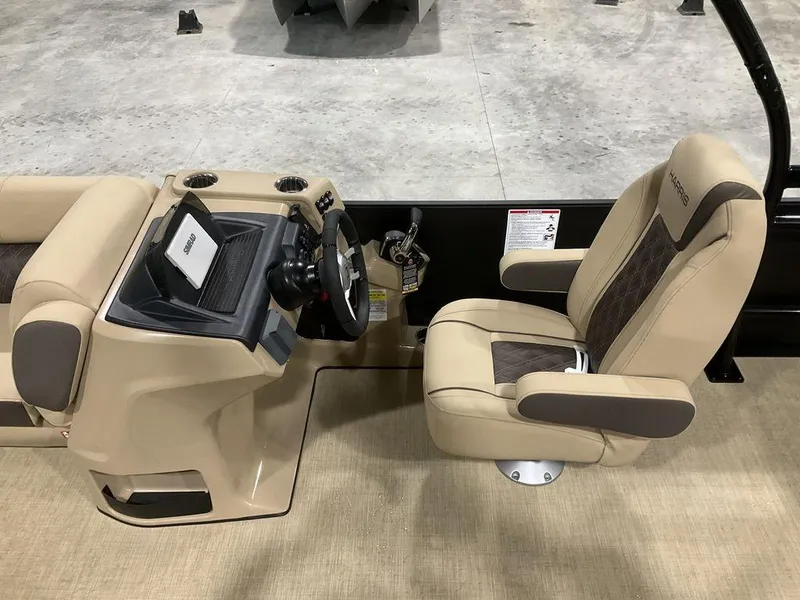Slide: The Image of 2025 Harris Sunliner 230 Sport SLDH boat interior with beige captain's chair and steering console. - 4
