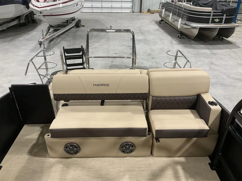 Slide: The Image of 2025 Harris Sunliner 230 Sport SLDH boat interior with beige seating and cup holders. - 6