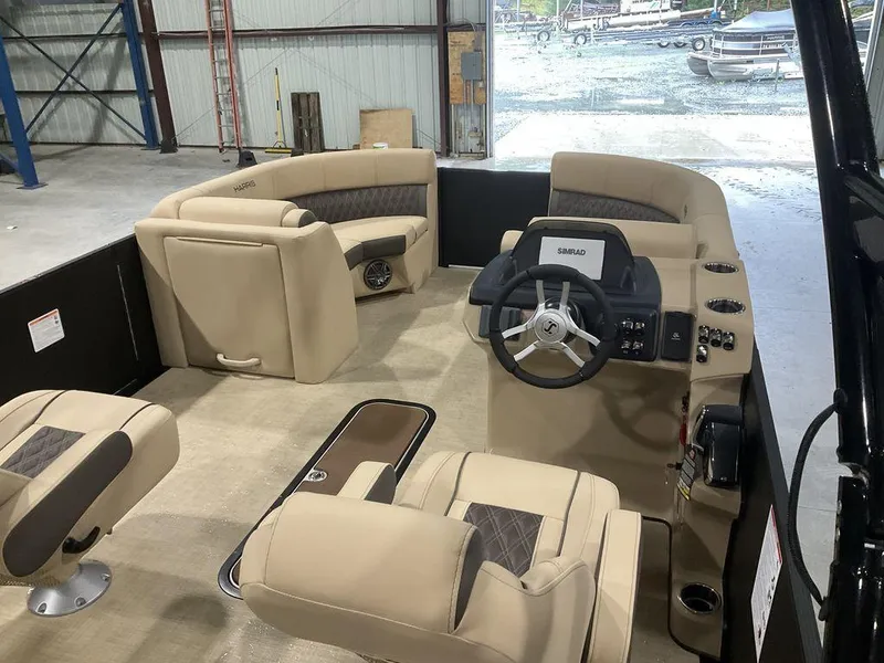Slide: The Image of 2025 Harris Sunliner 230 Sport SLDH interior with beige seating and steering console. - 7
