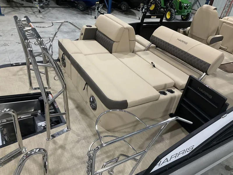 Slide: The Image of 2025 Harris Sunliner 230 Sport SLDH boat interior with beige seating and stainless steel railings. - 9