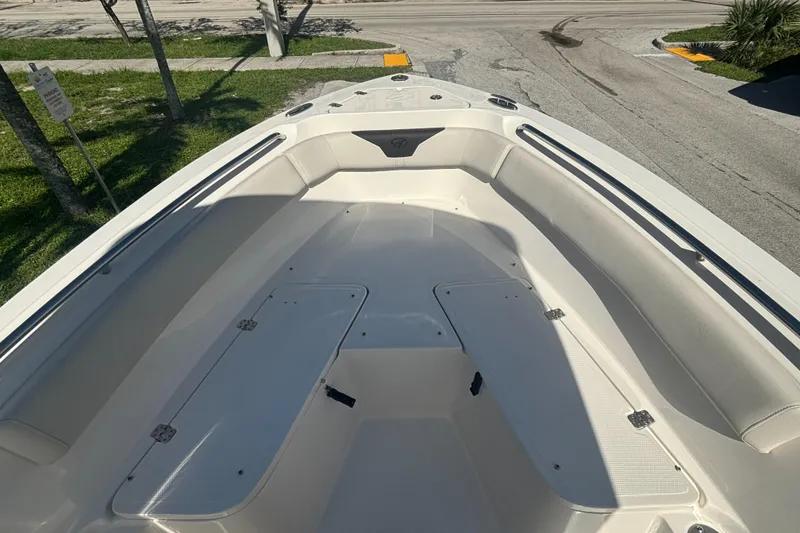 Slide: The Image of 2023 Sailfish 220 CC boat interior with spacious seating and storage compartments. - 7