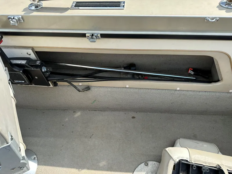 Slide: The Image of 1994 Lund 1850 Tyee boat interior storage compartment with fishing rod holder. - 11