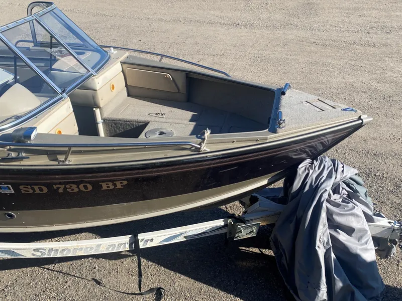 Slide: The Image of 1994 Lund 1850 Tyee boat on trailer, parked on gravel surface. - 14