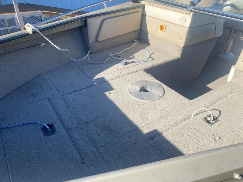 Slide: The Image of Interior of a 1994 Lund 1850 Tyee boat, showing spacious seating and storage areas. - 16